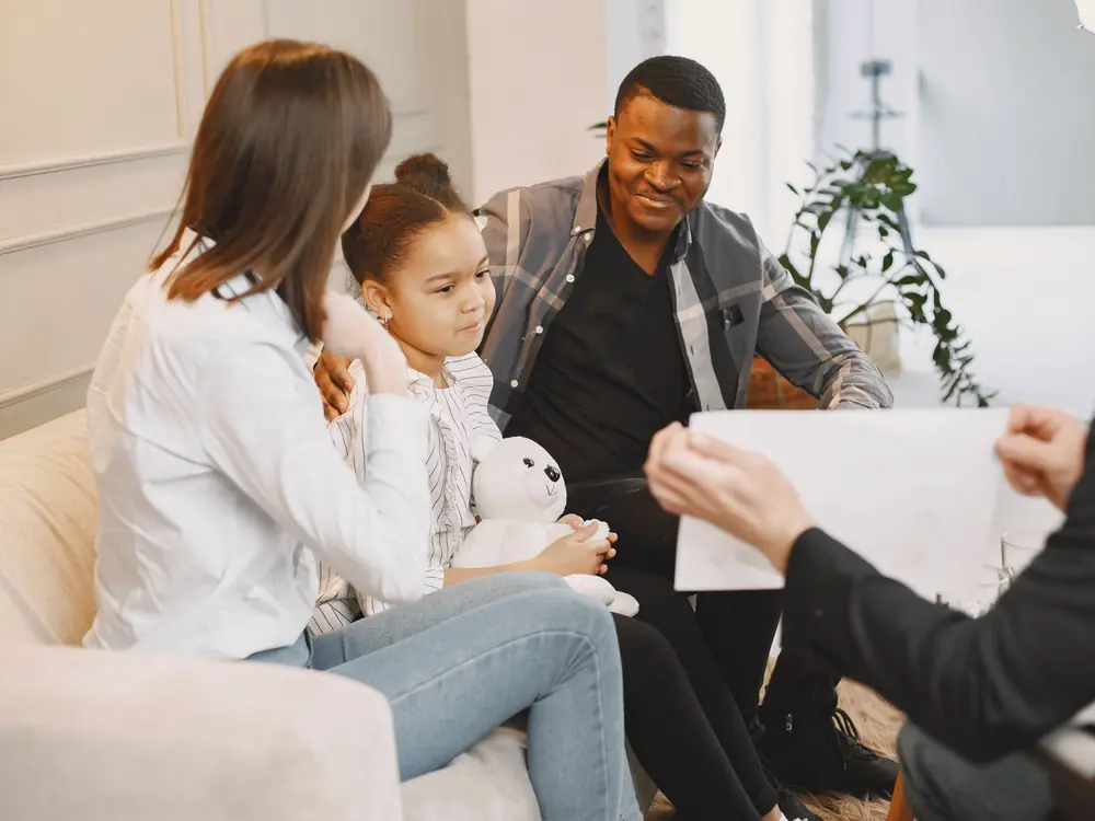 Parents and their daughter participating together in a family therapy session