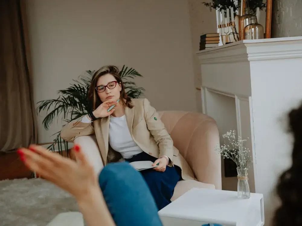 A counselor listening attentively to a client during an individual therapy session